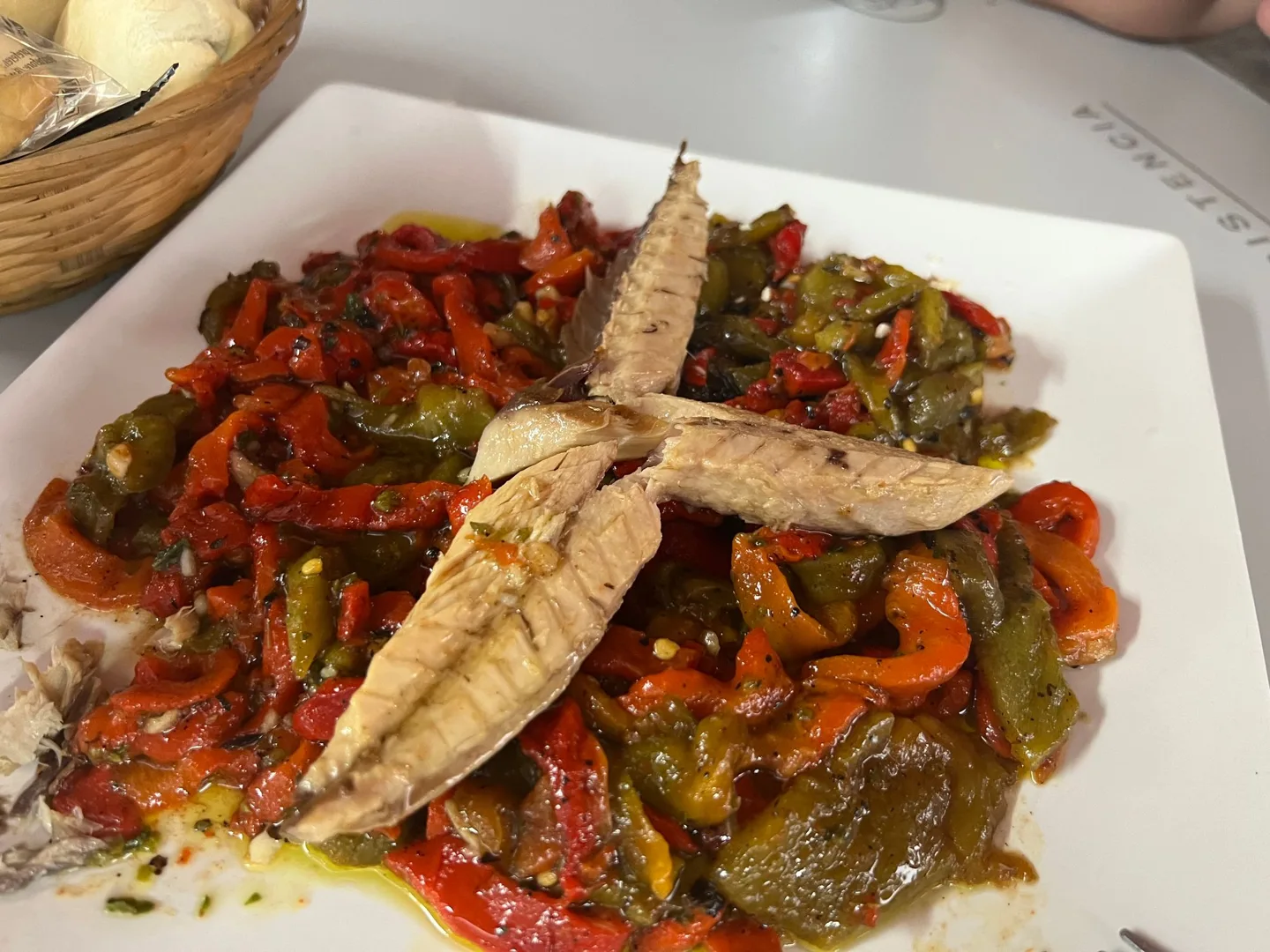 Grilled fish served over vegetables
