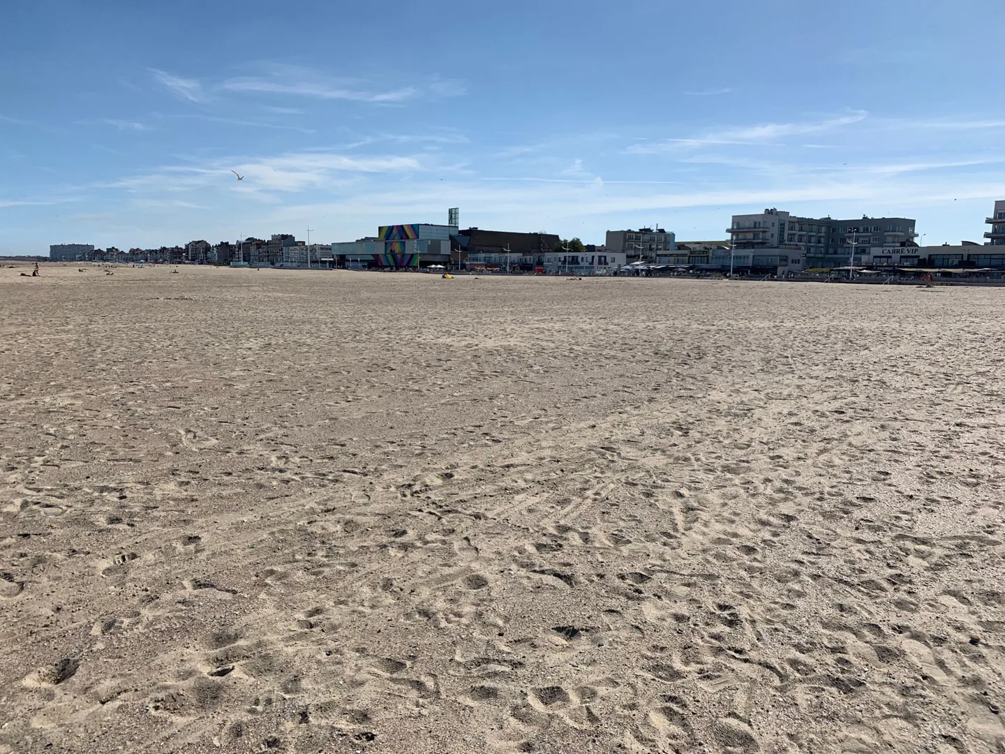 Sandy beach with buildings in the distance