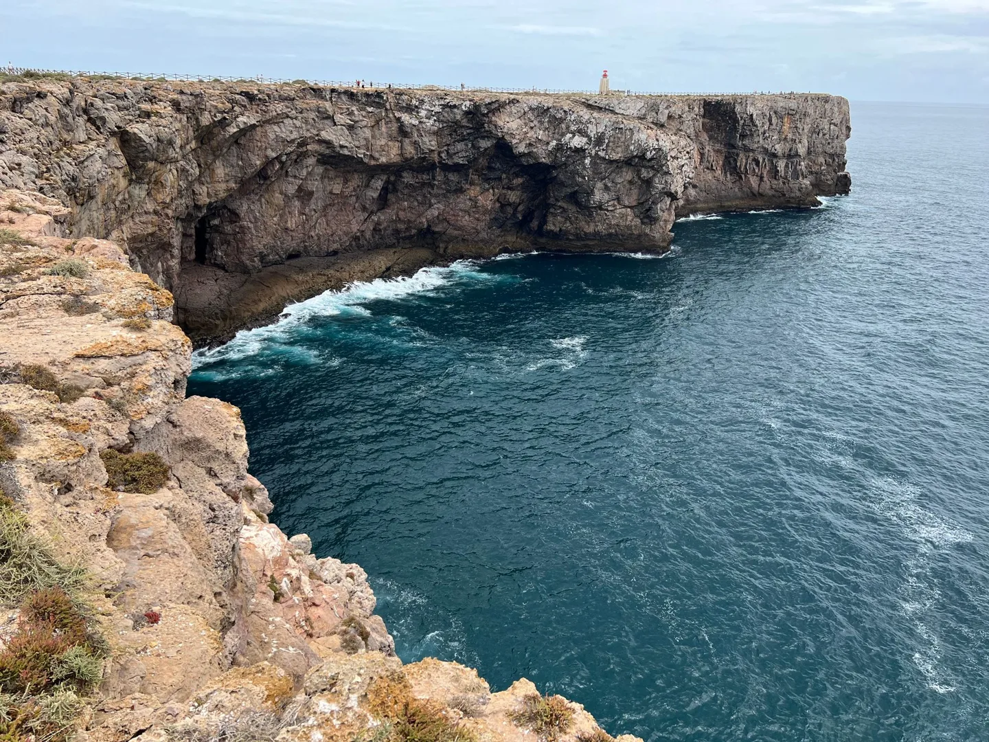 Waves breaking beneath a rocky headland