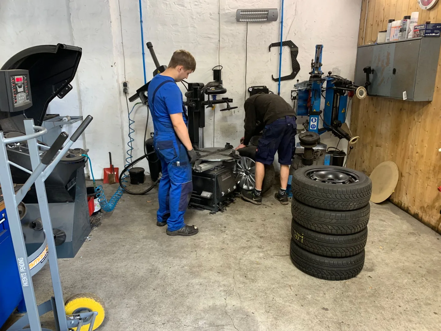 Tire workshop with a car raised for repairs