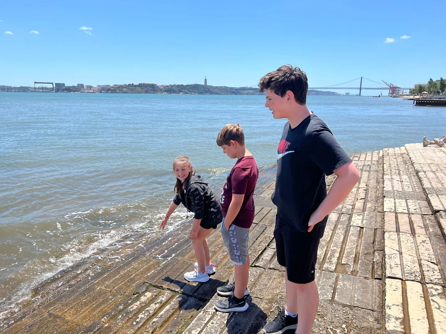 Children standing beside the waterfront