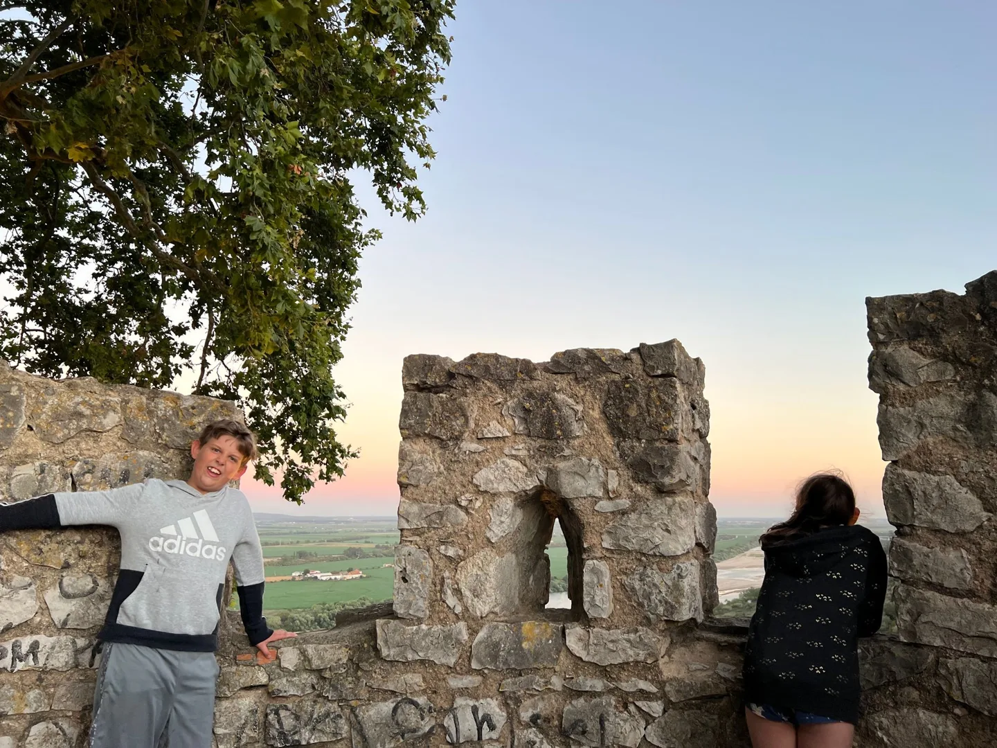 Children beside stone battlements