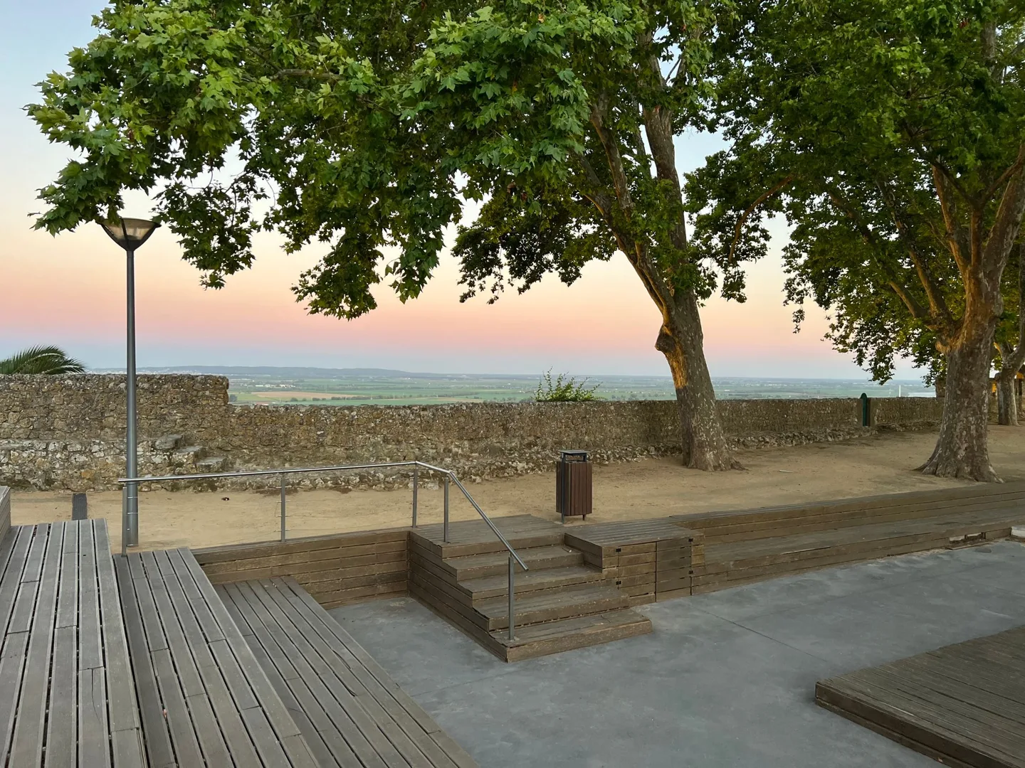 Shaded terrace beside stone walls