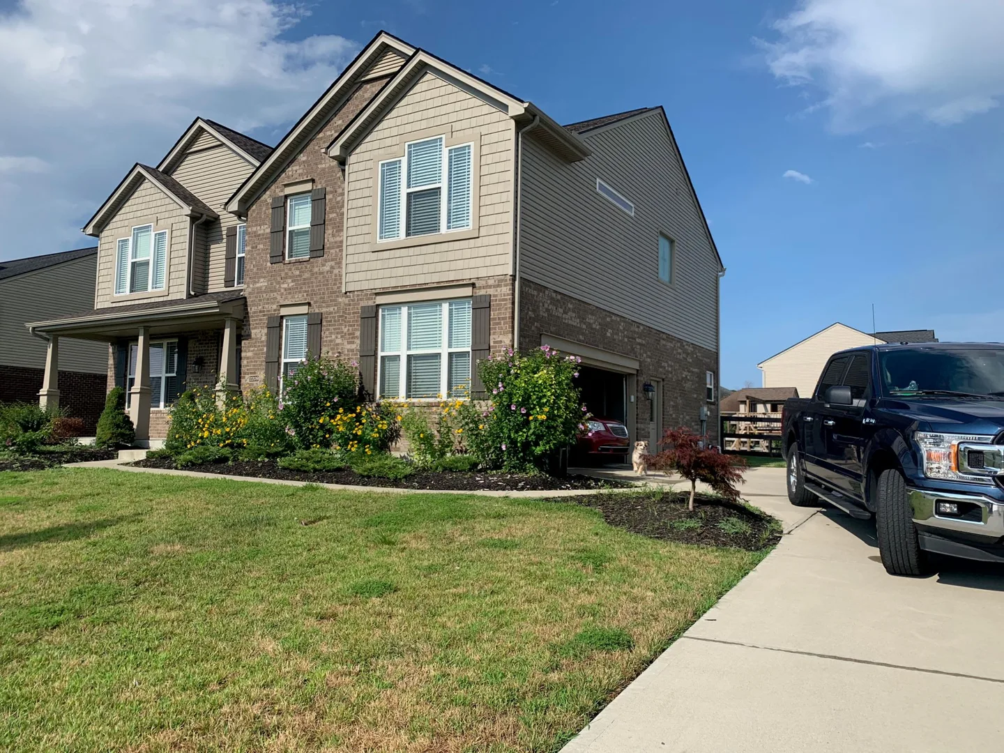 Our house with its front lawn and driveway