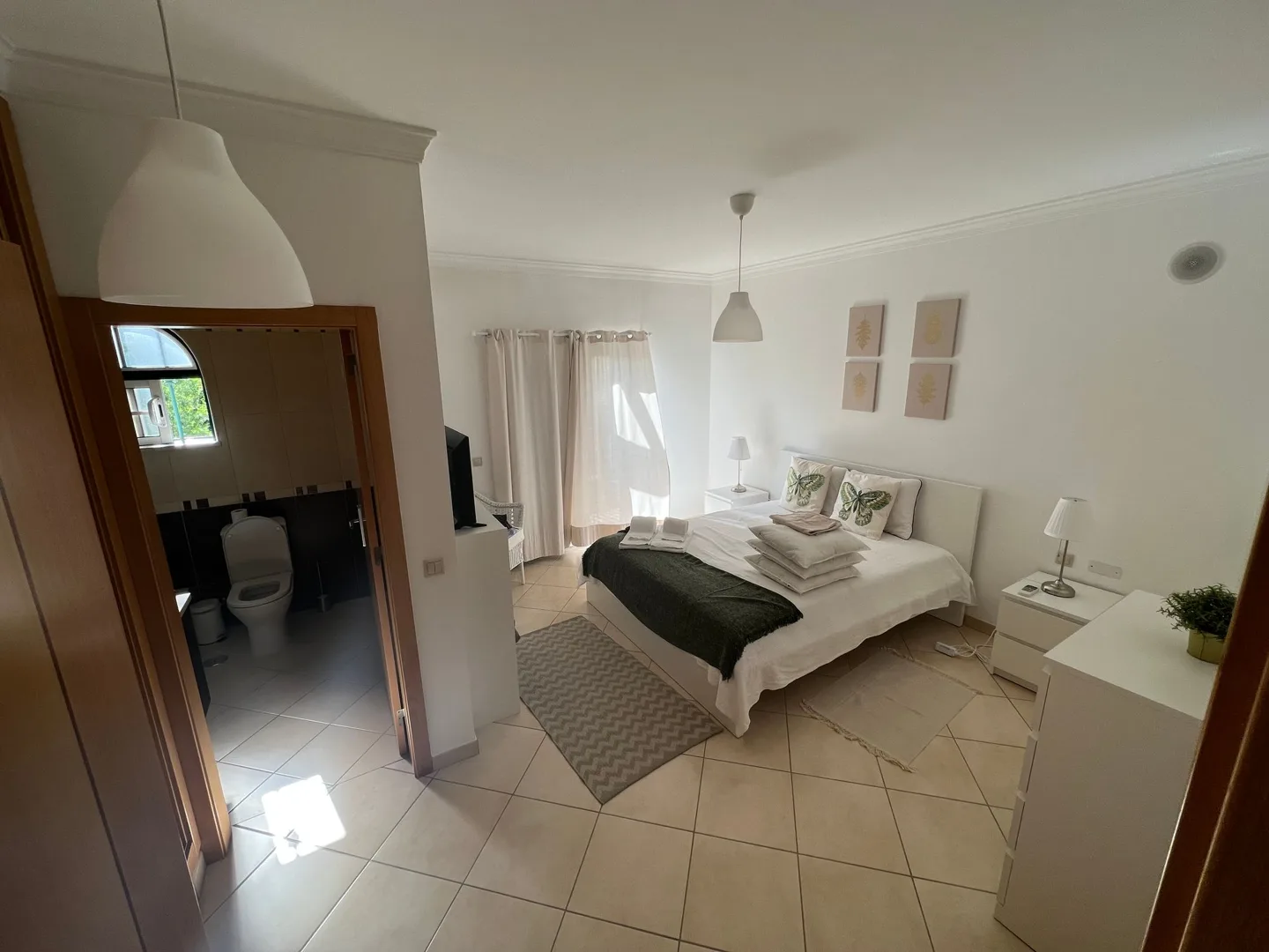 Bright white living room in our holiday apartment