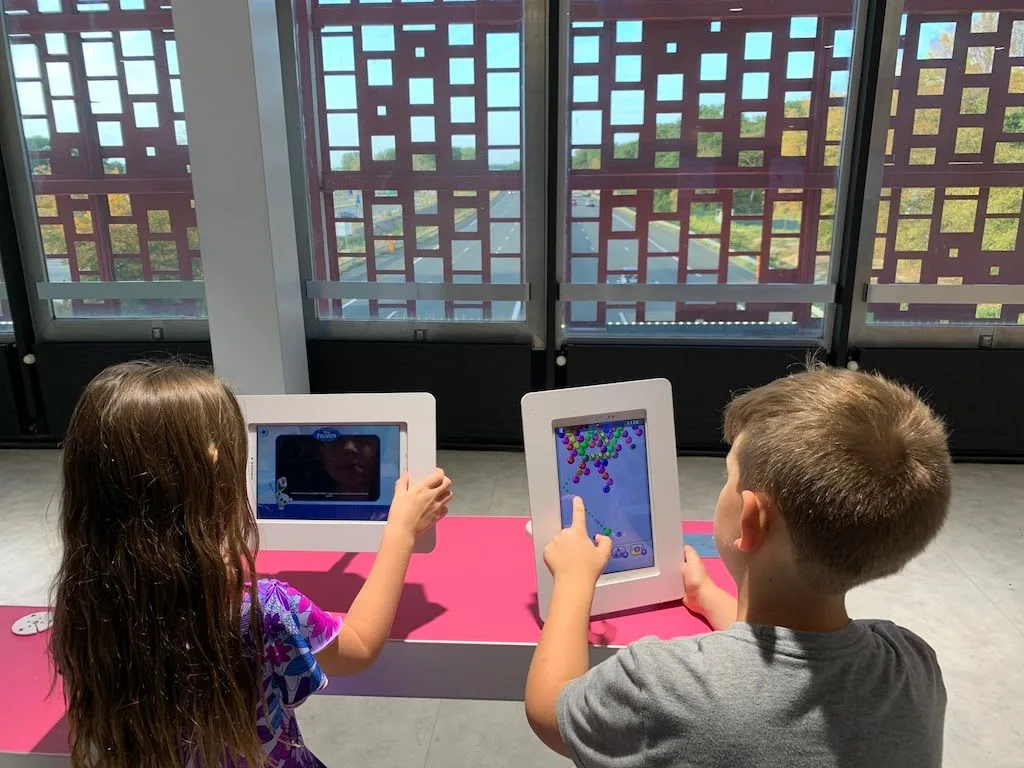 Children using tablets at a restaurant counter