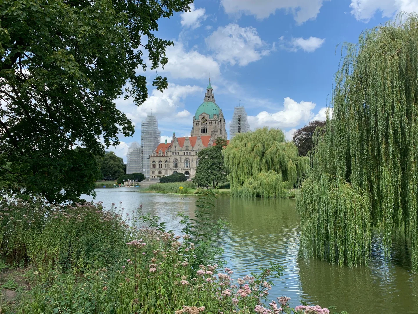 Hannover's New Town Hall beyond a tree-lined pond