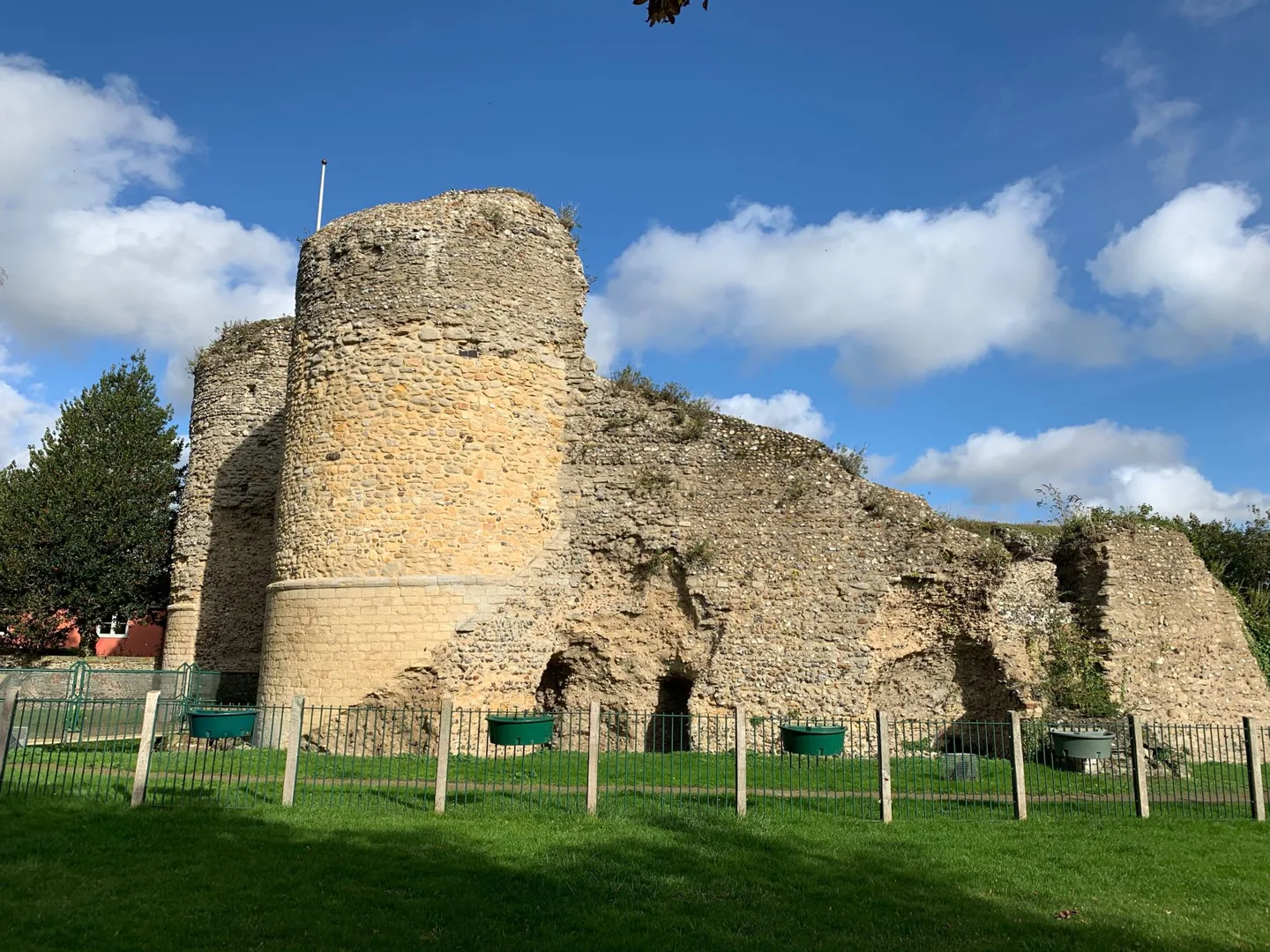 Round stone tower and ruined walls
