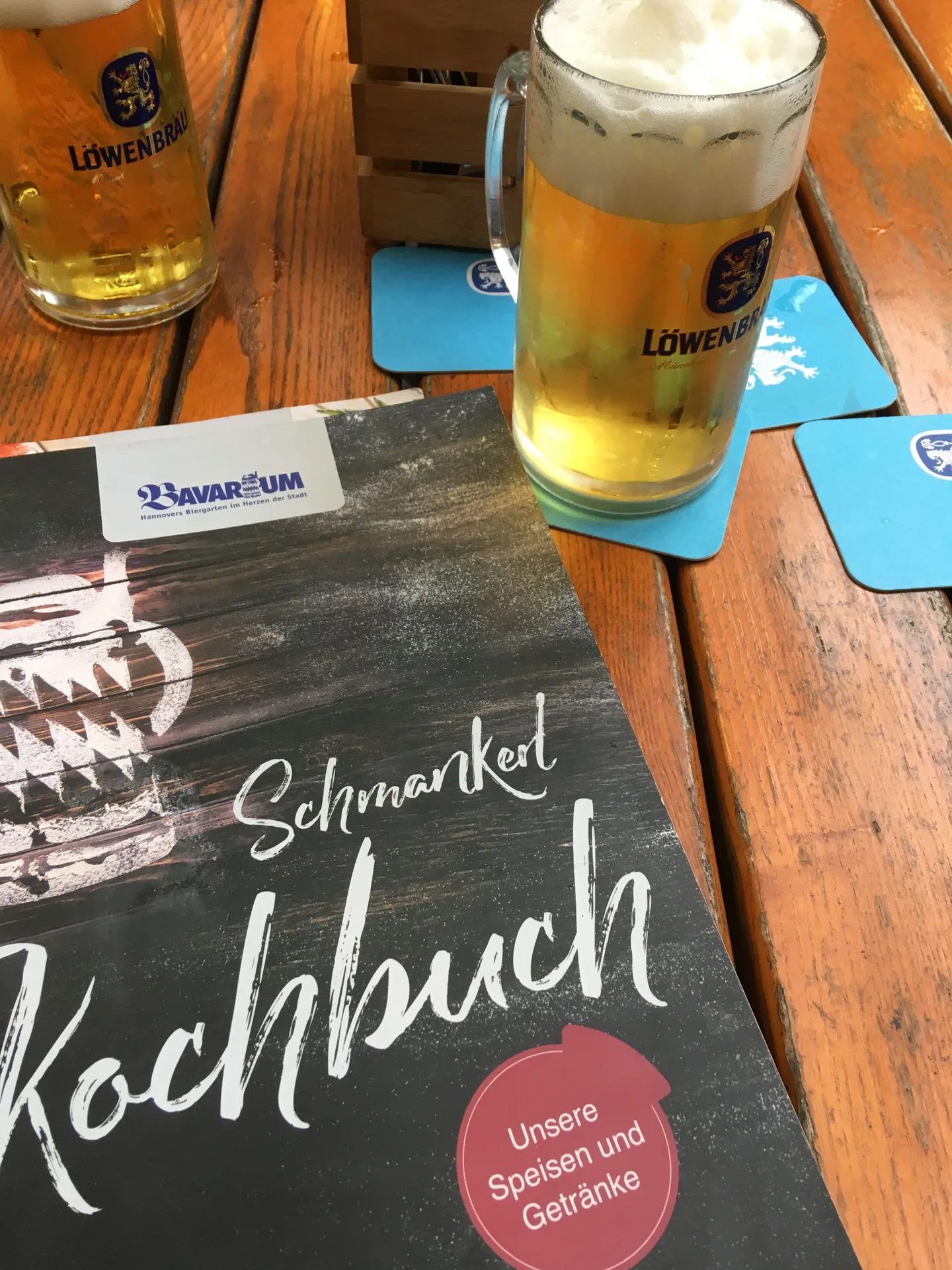 Glass of beer beside a restaurant menu