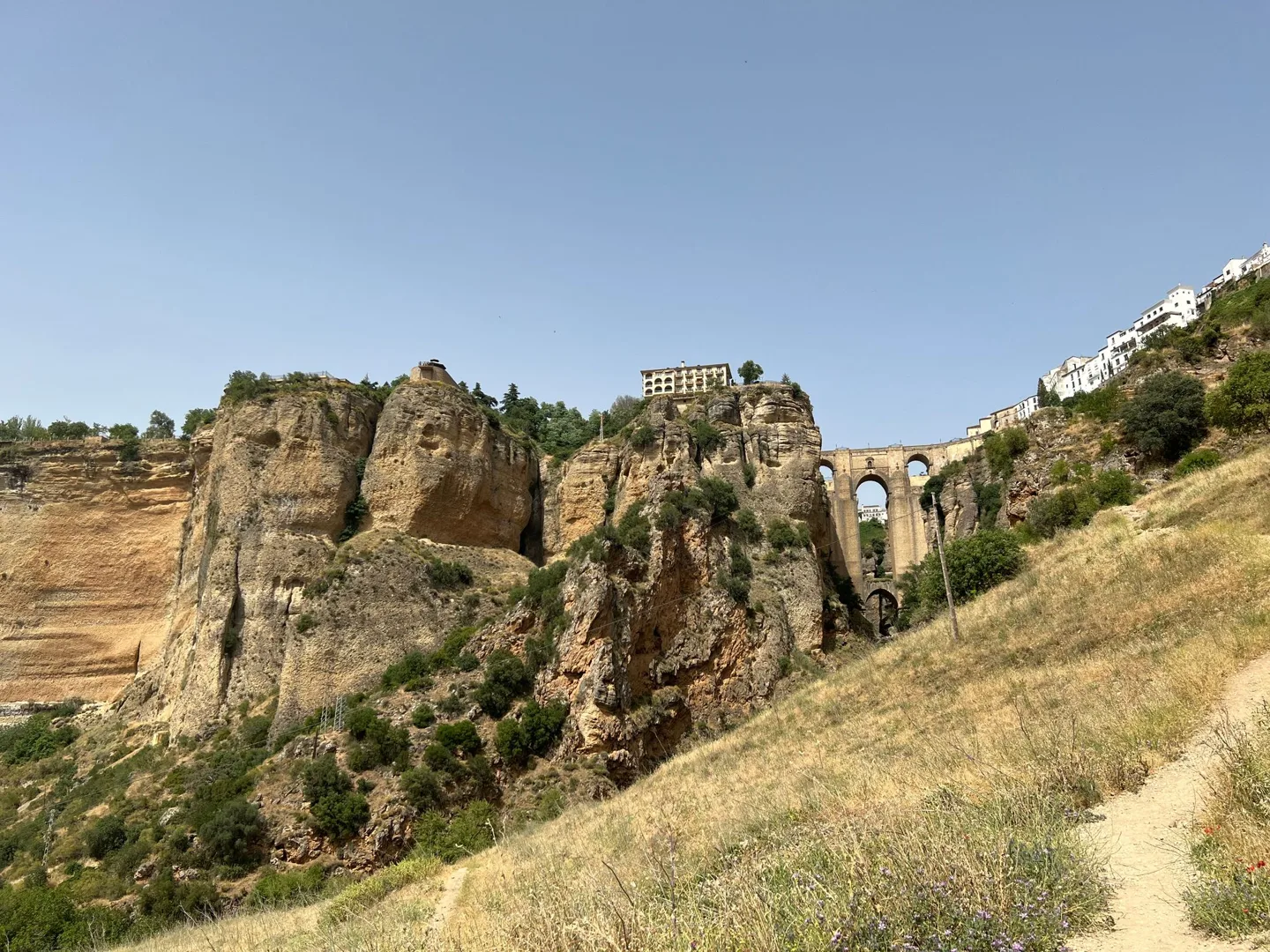 Rock formations and hillside below the town