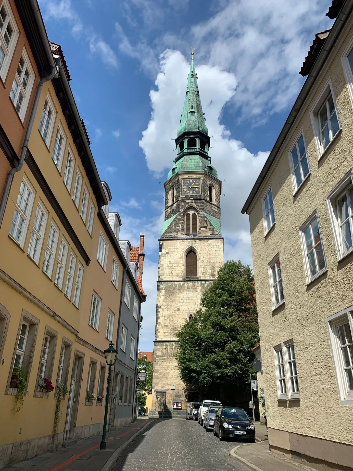 Narrow street leading toward a church tower