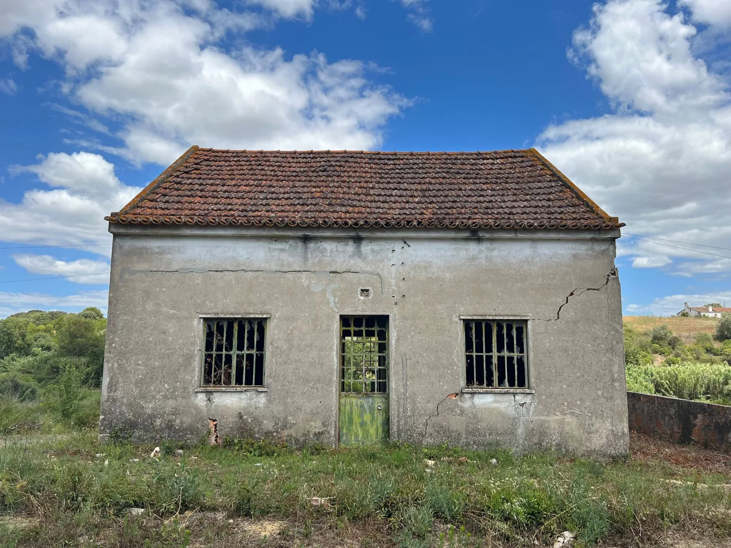 Small white building with a red tiled roof