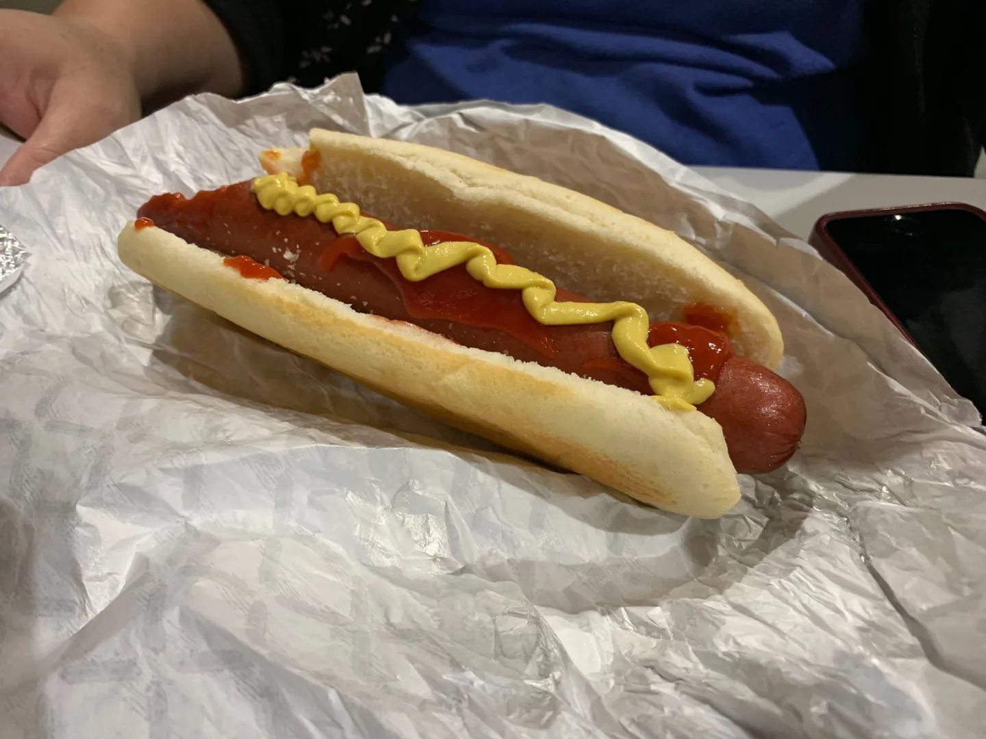 Hot dog topped with mustard