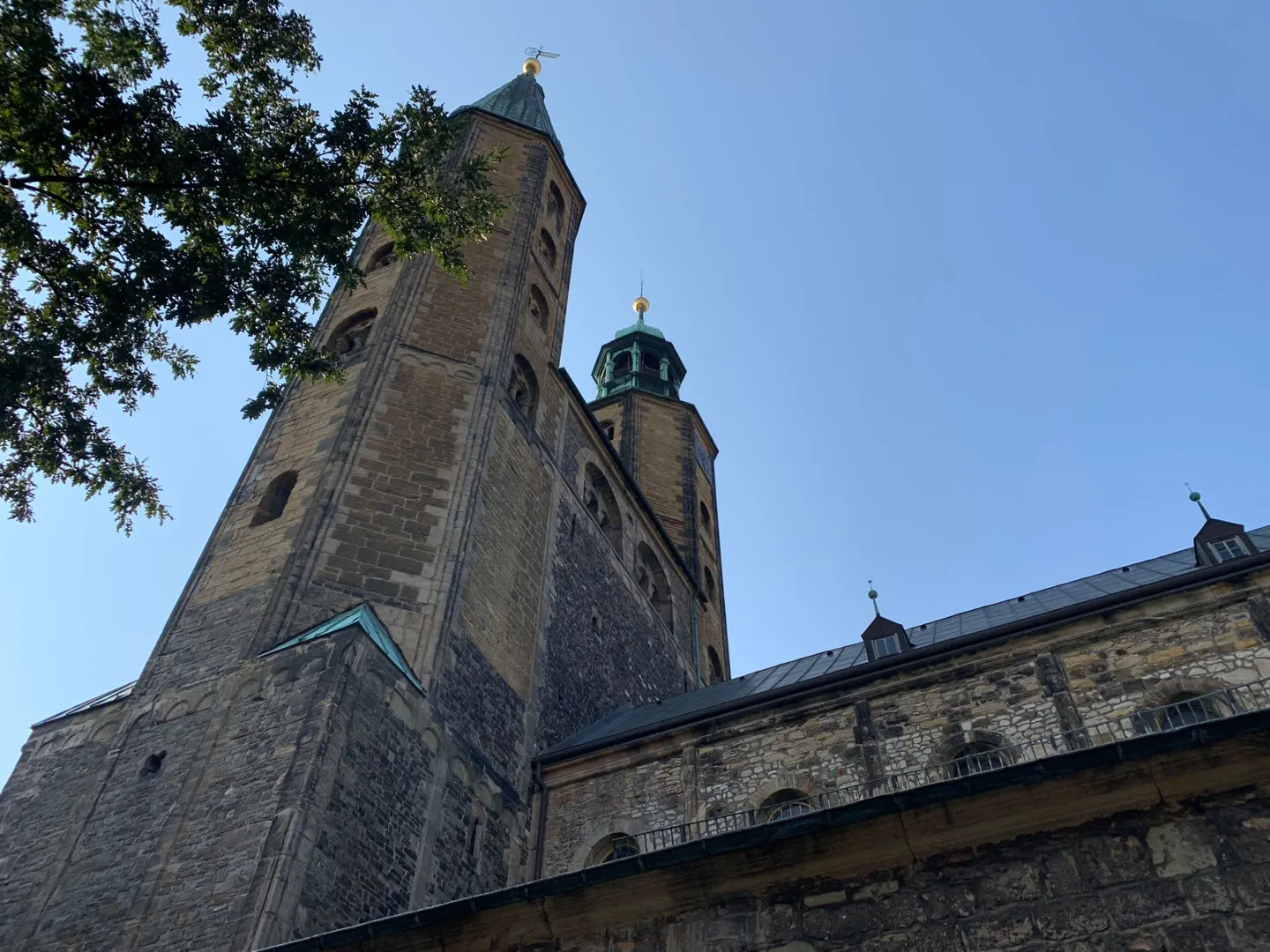 Stone church tower beneath a blue sky